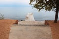 Wooden pier with benches with tree and stone road on beach to sea. Rest, travel, tranquility, sunset and sunrise Royalty Free Stock Photo