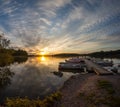 Wooden pier and a boat on a lake sunset. Royalty Free Stock Photo