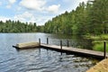 Wooden Pier and boat on Leonard Pond, Colton, St. Lawrence County, New York, United States. NY. US. USA.