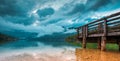 Wooden pier at Bohinj lake on cloudy autumn day