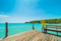 Wooden pier or bridge with tropical beach and sea in paradise is Royalty Free Stock Photo