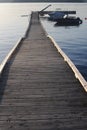 Wooden pier or deck in a calm sea before sunset in summer