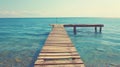 Wooden Pier Extending into Calm Blue Sea Royalty Free Stock Photo