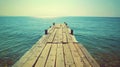 Wooden Pier Extending into Calm Blue Sea Royalty Free Stock Photo