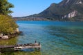 A wooden pier extends into a crystal clear alpine lake in Autumn Royalty Free Stock Photo