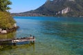 A wooden pier extends into a crystal clear alpine lake in Autumn Royalty Free Stock Photo