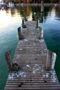 A wooden pier extends into a crystal clear alpine lake in Autumn, France Royalty Free Stock Photo