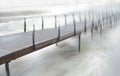 Wooden pier with fast flowing water Royalty Free Stock Photo