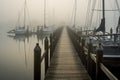 Wooden pier in a foggy morning. Yachts and boats in the background, AI Generated Royalty Free Stock Photo