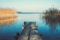 Wooden pier or footbridge on tranquil blue lake