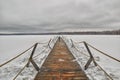 Wooden pier on a frozen winter lake Royalty Free Stock Photo
