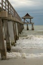 Wooden pier, with gentle waves of the ocean lapping against it