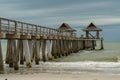 Wooden pier, with gentle waves of the ocean lapping against it