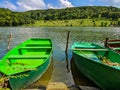 Wooden pier or jetty and a boat on lake sunset and sky reflection water. Royalty Free Stock Photo