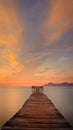 Wooden pier / jetty, playa de muro, Alcudia, sunrise, mountains, secluded beach, golden sunlight, reflection, beautiful sky, Royalty Free Stock Photo