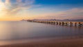 Wooden pier / jetty, playa de muro, Alcudia, sunrise, mountains, secluded beach, golden sunlight, reflection, beautiful sky, Royalty Free Stock Photo