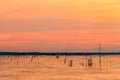 Wooden pier or jetty remains on a blue lake sunset and cloudy sk Royalty Free Stock Photo