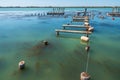 Wooden pier or jetty remains on a blue lake sunset Royalty Free Stock Photo