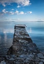 Wooden pier or jetty on the sea with blue sky and blue water. Beautiful Landscape photo Royalty Free Stock Photo