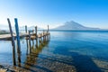 Wooden pier at Lake Atitlan on the beach in Panajachel, Guatemala. With beautiful landscape scenery of volcanoes Toliman, Atitlan Royalty Free Stock Photo