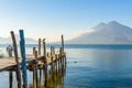 Wooden pier at Lake Atitlan on the beach in Panajachel, Guatemala. With beautiful landscape scenery of volcanoes Toliman, Atitlan