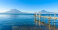 Wooden pier at Lake Atitlan on the beach in Panajachel, Guatemala. With beautiful landscape scenery of volcanoes Toliman, Atitlan Royalty Free Stock Photo