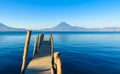 Wooden pier at Lake Atitlan on the beach in Panajachel, Guatemala. With beautiful landscape scenery of volcanoes Toliman, Atitlan Royalty Free Stock Photo