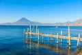 Wooden pier at Lake Atitlan on the beach in Panajachel, Guatemala. With beautiful landscape scenery of volcanoes Toliman, Atitlan Royalty Free Stock Photo