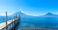 Wooden pier at Lake Atitlan on the beach in Panajachel, Guatemala. With beautiful landscape scenery of volcanoes Toliman, Atitlan