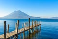 Wooden pier at Lake Atitlan on the beach in Panajachel, Guatemala. With beautiful landscape scenery of volcanoes Toliman, Atitlan Royalty Free Stock Photo