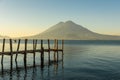 Wooden pier at Lake Atitlan on the beach in Panajachel, Guatemala. With beautiful landscape scenery of volcanoes Toliman, Atitlan Royalty Free Stock Photo