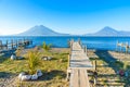 Wooden pier at Lake Atitlan on the beach in Panajachel, Guatemala.  With beautiful landscape scenery of volcanoes Toliman, Atitlan Royalty Free Stock Photo