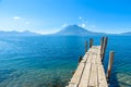 Wooden pier at Lake Atitlan on the beach in Panajachel, Guatemala. With beautiful landscape scenery of volcanoes Toliman, Atitlan Royalty Free Stock Photo