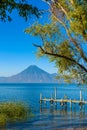 Wooden pier at Lake Atitlan on the shore at Panajachel, Guatemala.  With beautiful landscape scenery of volcanoes Toliman, Atitlan Royalty Free Stock Photo