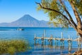 Wooden pier at Lake Atitlan on the shore at Panajachel, Guatemala.  With beautiful landscape scenery of volcanoes Toliman, Atitlan Royalty Free Stock Photo