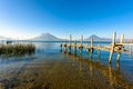 Wooden pier at Lake Atitlan on the shore at Panajachel, Guatemala.  With beautiful landscape scenery of volcanoes Toliman, Atitlan Royalty Free Stock Photo