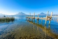 Wooden pier at Lake Atitlan on the shore at Panajachel, Guatemala.  With beautiful landscape scenery of volcanoes Toliman, Atitlan Royalty Free Stock Photo