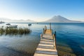 Wooden pier at Lake Atitlan on the shore at Panajachel, Guatemala.  With beautiful landscape scenery of volcanoes Toliman, Atitlan Royalty Free Stock Photo