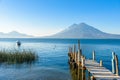 Wooden pier at Lake Atitlan on the shore at Panajachel, Guatemala.  With beautiful landscape scenery of volcanoes Toliman, Atitlan Royalty Free Stock Photo