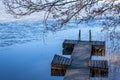 A wooden pier in a lake on a cold autumn day in southern Finland Royalty Free Stock Photo