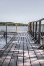 Boardwalk pier and calm water in a rural landscape Royalty Free Stock Photo