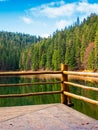 wooden pier on the lake synevyr in autumn