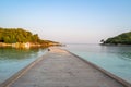 Wooden pier in the turquoise sea with blue sky Royalty Free Stock Photo