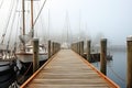 Wooden pier in the misty morning. Yachts and boats, AI Generated Royalty Free Stock Photo