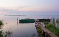 Wooden Pier with Moored Boats on the Lake During Dawn Royalty Free Stock Photo