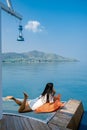 wooden pier in ocean Pattaya Bangsaray beach Thailand, woman relaxing on wooden pier during vacation Thailand Royalty Free Stock Photo