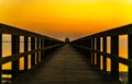 Long boardwalk pier by the sea at sunset Royalty Free Stock Photo