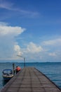 Wooden pier over blue water of the sea Royalty Free Stock Photo
