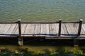 View of the water surface with a plank pier Royalty Free Stock Photo