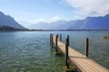 Wooden pier overlooking the Swiss Alps and Lake Geneva Royalty Free Stock Photo